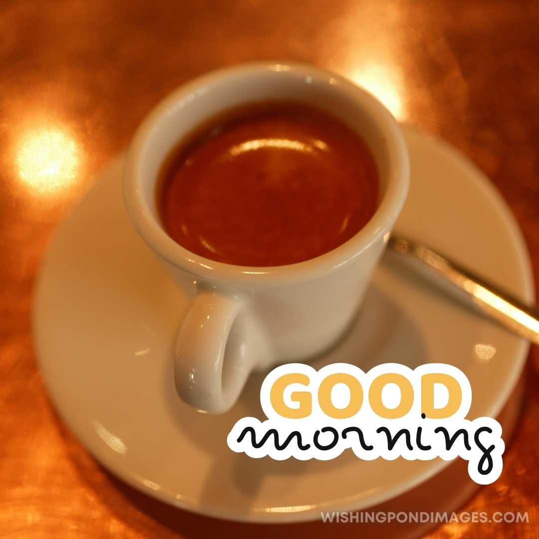 A cup of coffee in the plate with spoon on the table. Good Morning Coffee Images
